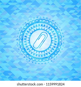 paper clip icon inside light blue mosaic emblem
