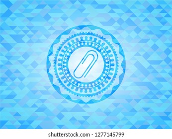 paper clip icon inside light blue emblem with triangle mosaic background