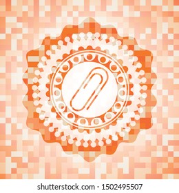 paper clip icon inside orange mosaic emblem with background