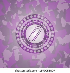 paper clip icon inside pink and purple camouflaged emblem