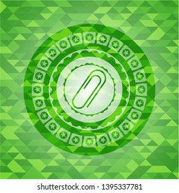 paper clip icon inside realistic green emblem. Mosaic background
