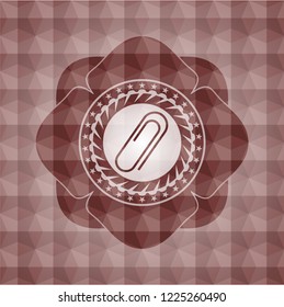 paper clip icon inside red seamless geometric badge.
