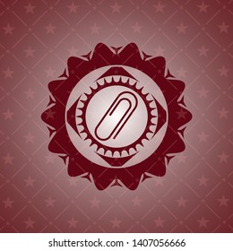 paper clip icon inside red emblem