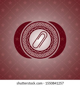 paper clip icon inside red emblem