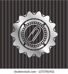paper clip icon inside silver emblem