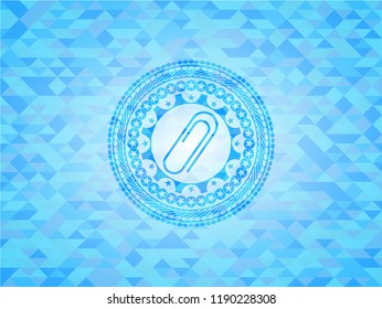 paper clip icon inside sky blue emblem with triangle mosaic background
