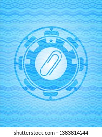 paper clip icon inside sky blue water style emblem.
