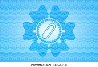 paper clip icon inside sky blue water wave badge background.