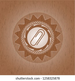 paper clip icon inside vintage wood emblem