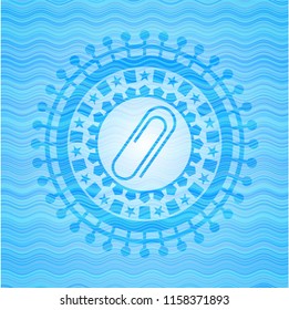 paper clip icon inside water wave representation style emblem.