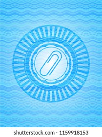 paper clip icon inside water badge background.