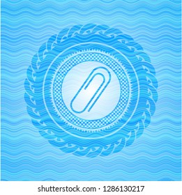 paper clip icon inside water emblem background.