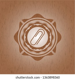paper clip icon inside wood badge or emblem