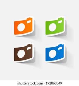 Paper clipped sticker: Digital compact photo camera. Isolated illustration icon