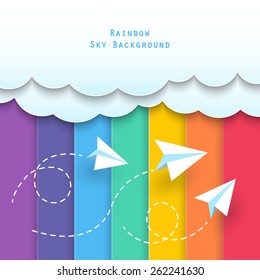 paper clouds and planes flying in summer with rainbow sky background.