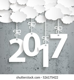 Paper clouds with text 2017 on the concrete background. Eps 10 vector file.