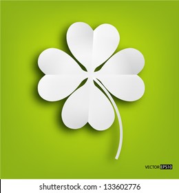 Paper clover leaf on green background.