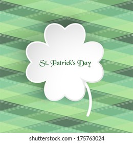 Paper clover leaf on green background.