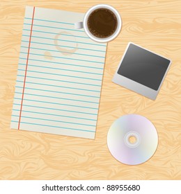 Paper, coffee, photo and disc on the table