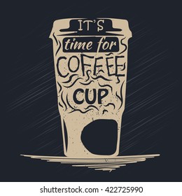 Paper cup of coffee with lettering inside. Coffe cup on dark background
