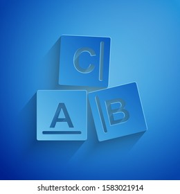 Paper cut ABC blocks icon isolated on blue background. Alphabet cubes with letters A,B,C. Paper art style. Vector Illustration