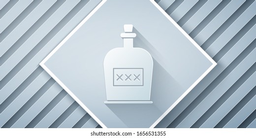 Paper cut Alcohol drink Rum bottle icon isolated on grey background. Paper art style. Vector Illustration