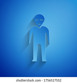 Paper cut Alien icon isolated on blue background. Extraterrestrial alien face or head symbol. Paper art style. Vector Illustration