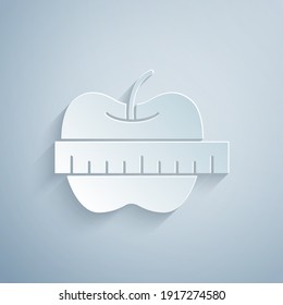 Paper cut Apple and measuring tape icon isolated on grey background. Excess weight. Healthy diet menu. Fitness diet apple. Paper art style. Vector.