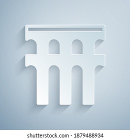 Paper cut Aqueduct of Segovia, Spain icon isolated on grey background. Roman Aqueduct building. National symbol of Spain. Paper art style. Vector. svg