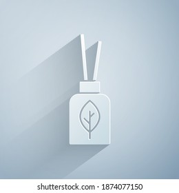 Paper cut Aroma diffuser icon isolated on grey background. Glass jar different with wooden aroma sticks. Paper art style. Vector