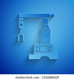 Paper cut Assembly line icon isolated on blue background. Automatic production conveyor. Robotic industry concept. Paper art style. Vector Illustration