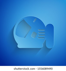 Paper cut Astronaut helmet icon isolated on blue background. Paper art style. Vector Illustration