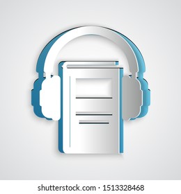 Paper cut Audio book icon isolated on grey background. Book with headphones. Audio guide sign. Online learning concept. Paper art style. Vector Illustration