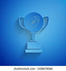 Paper cut Award cup and American football ball icon isolated on blue background. Winner trophy symbol. Championship or competition trophy. Paper art style. Vector Illustration Paper cut Award cup and American football ball icon isolated on blue background. Winner trophy symbol. Championship or competition trophy. Paper art style. Vector Illustration