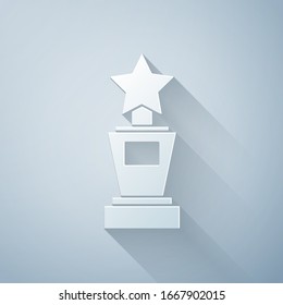 Paper cut Award cup icon isolated on grey background. Winner trophy symbol. Championship or competition trophy. Sports achievement sign. Paper art style. Vector Illustration