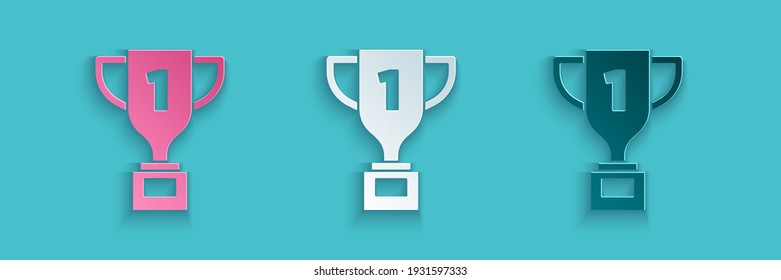 Paper cut Award cup icon isolated on blue background. Winner trophy symbol. Championship or competition trophy. Sports achievement sign. Paper art style. Vector