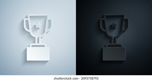 Paper cut Award cup icon isolated on grey and black background. Winner trophy symbol. Championship or competition trophy. Sports achievement sign. Paper art style. Vector