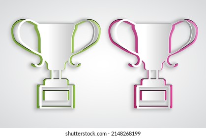 Paper cut Award cup icon isolated on grey background. Winner trophy symbol. Championship or competition trophy. Sports achievement sign. Paper art style. Vector