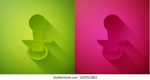 Paper cut Baby dummy pacifier icon isolated on green and pink background. Toy of a child. Paper art style. Vector