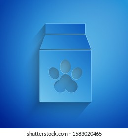 Paper cut Bag of food for pet icon isolated on blue background. Food for animals. Pet food package. Dog or cat paw print. Paper art style. Vector Illustration