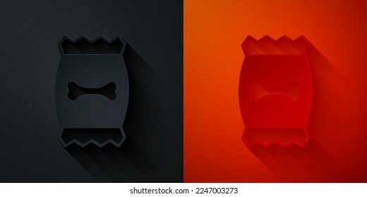 Paper cut Bag of food for pet icon isolated on black and red background. Food for animals. Dog bone sign. Pet food package. Paper art style. Vector