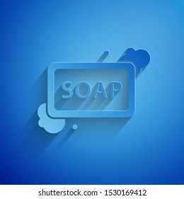 Paper cut Bar of soap with foam icon isolated on blue background. Soap bar with bubbles. Paper art style. Vector Illustration