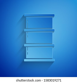 Paper cut Barrel oil icon isolated on blue background. Paper art style. Vector Illustration