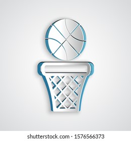 Paper cut Basketball ball and basket icon isolated on grey background. Ball in basketball hoop. Paper art style. Vector Illustration