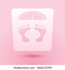 Paper cut Bathroom scales with footprints icon isolated on pink background. Weight measure Equipment. Weight Scale fitness sport concept. Paper art style. Vector.