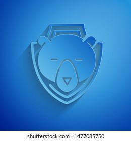 Paper cut Bear head on shield icon isolated on blue background. Hunting trophy on wall. Paper art style. Vector Illustration