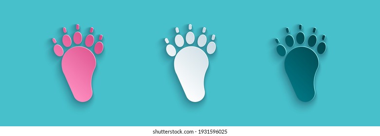 Paper cut Bear paw footprint icon isolated on blue background. Paper art style. Vector