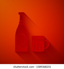 Paper cut Beer bottle and glass icon isolated on red background. Alcohol Drink symbol. Paper art style. Vector Illustration