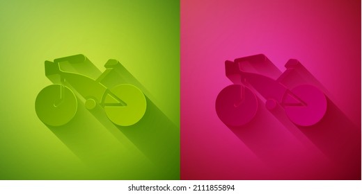 Paper cut Bicycle icon isolated on green and pink background. Bike race. Extreme sport. Sport equipment. Paper art style. Vector