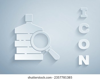Paper cut Big bottle with clean water and magnifying glass icon isolated on grey background. Plastic container for the cooler. Paper art style. Vector Illustration